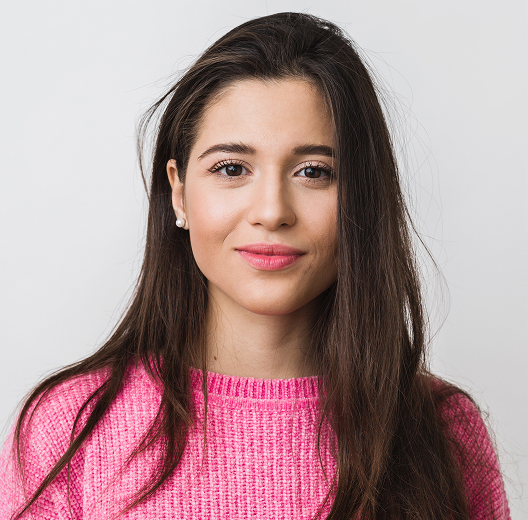 Woman in a pink sweater smiling