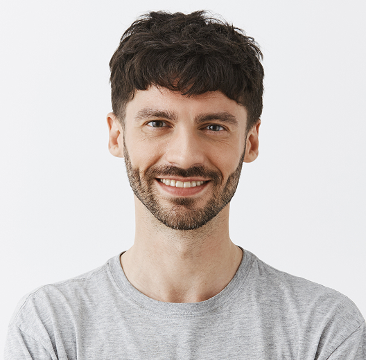 Man in a gray t-shirt smiling